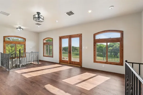 a view of an empty room with glass door and a window