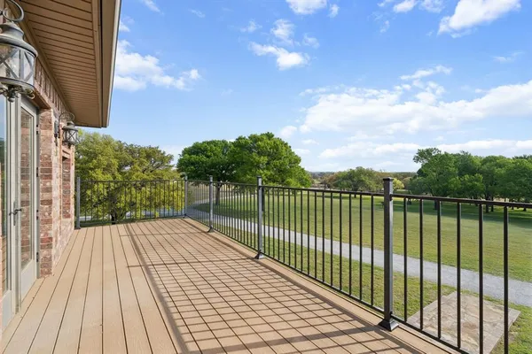 a view of a pathway with a wrought fence