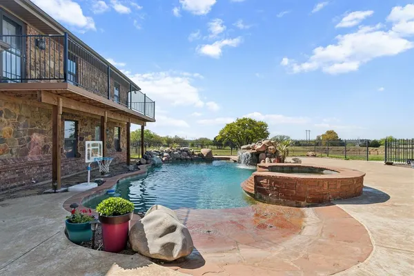 a view of a patio with couches and table and chairs and potted plants