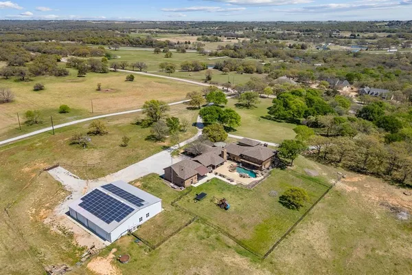 an aerial view of a residential houses with outdoor space