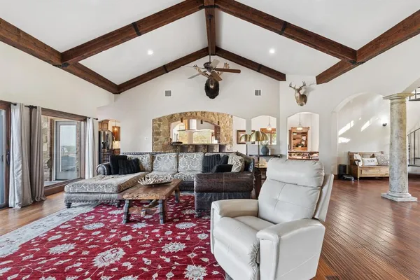 a living room with furniture and wooden floor