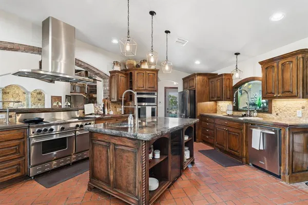 a kitchen with stainless steel appliances granite countertop a stove and a sink