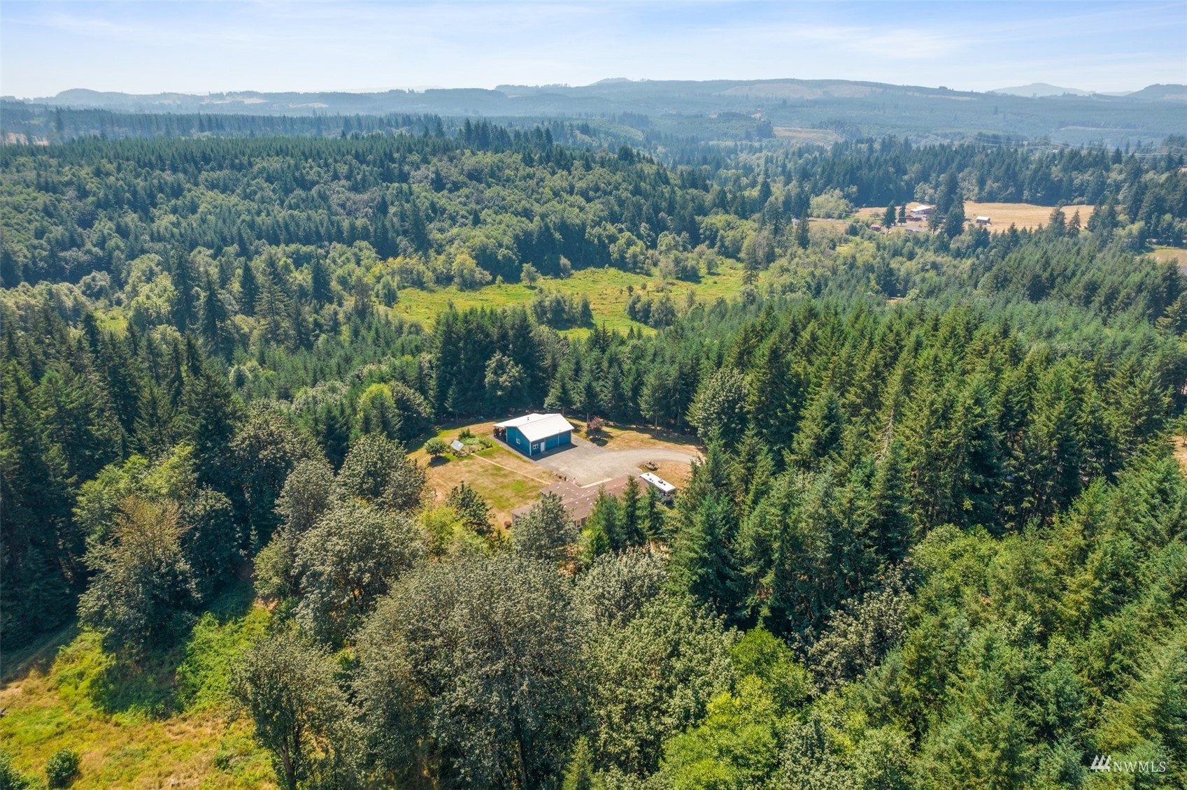 182 Holgate Lane Chehalis, WA 98532 - Photo 33 of 38 a view of a lush green forest with trees and some houses