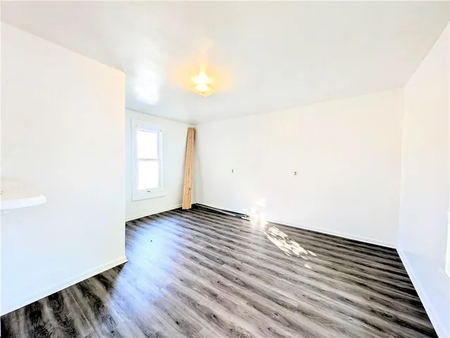 a view of an empty room and wooden floor
