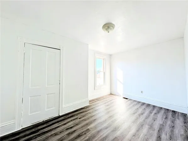 a view of a room with wooden floor