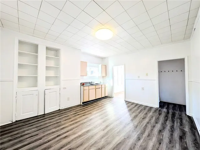 a view of a kitchen with wooden floor and a sink