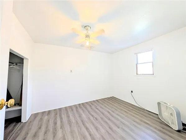 a view of a room with wooden floor and cabinet