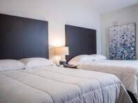 365 North Ocean Boulevard Boca Raton, FL 33432 - Photo 6 of 8 a bedroom with a bed and a painting on the wall