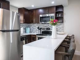 365 North Ocean Boulevard Boca Raton, FL 33432 - Photo 8 of 8 a kitchen with a sink a microwave a refrigerator and cabinets