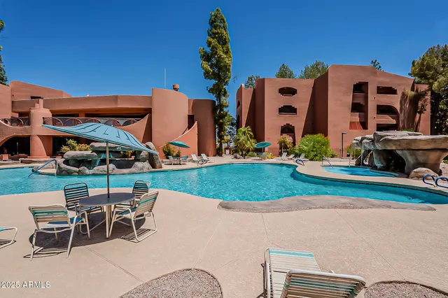 a view of a building with a table and chairs in patio