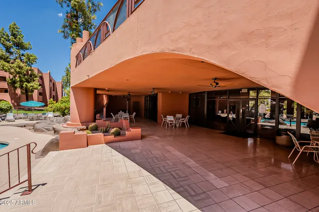 a view of a house with backyard porch and sitting area