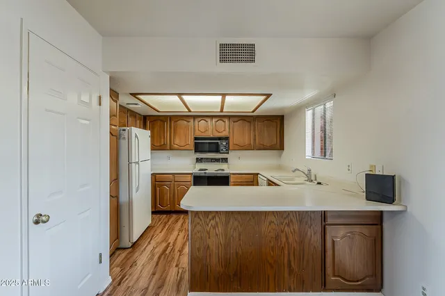 a kitchen with a sink cabinets and window