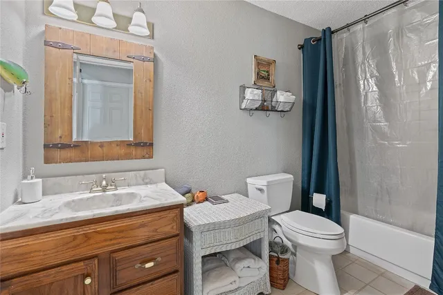 a bathroom with a toilet a sink and shower