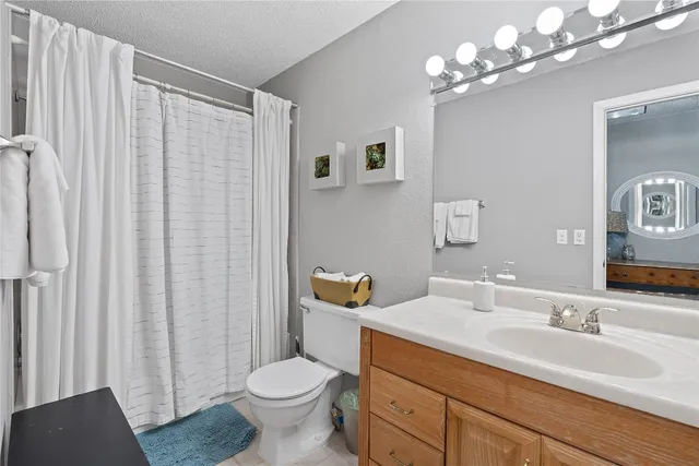 a bathroom with a toilet a sink and a mirror