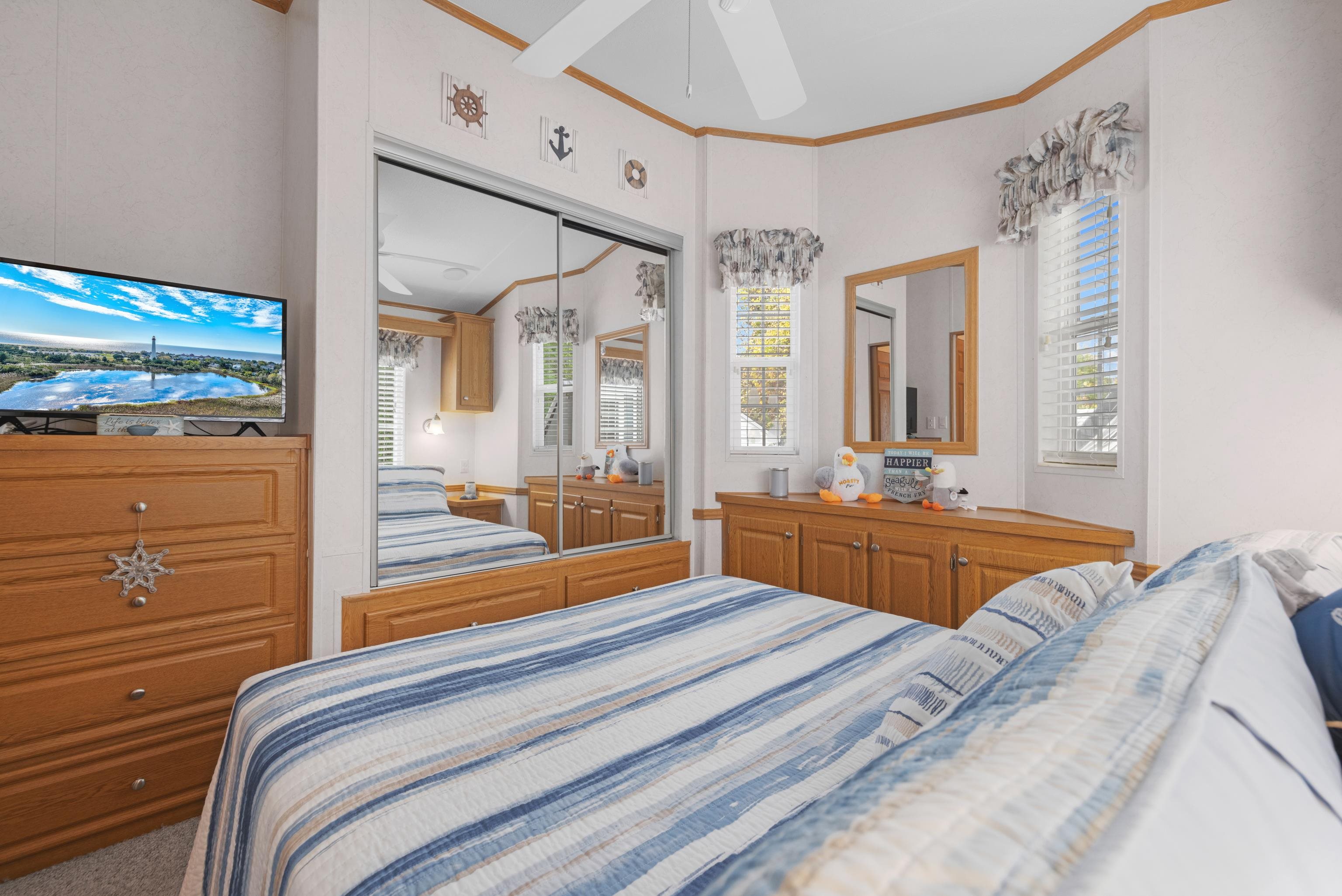 4100 Rte 9 South, Unit 6 Rio Grande, NJ 08242 - Photo 11 of 24 a bedroom with a bed and large mirror with window