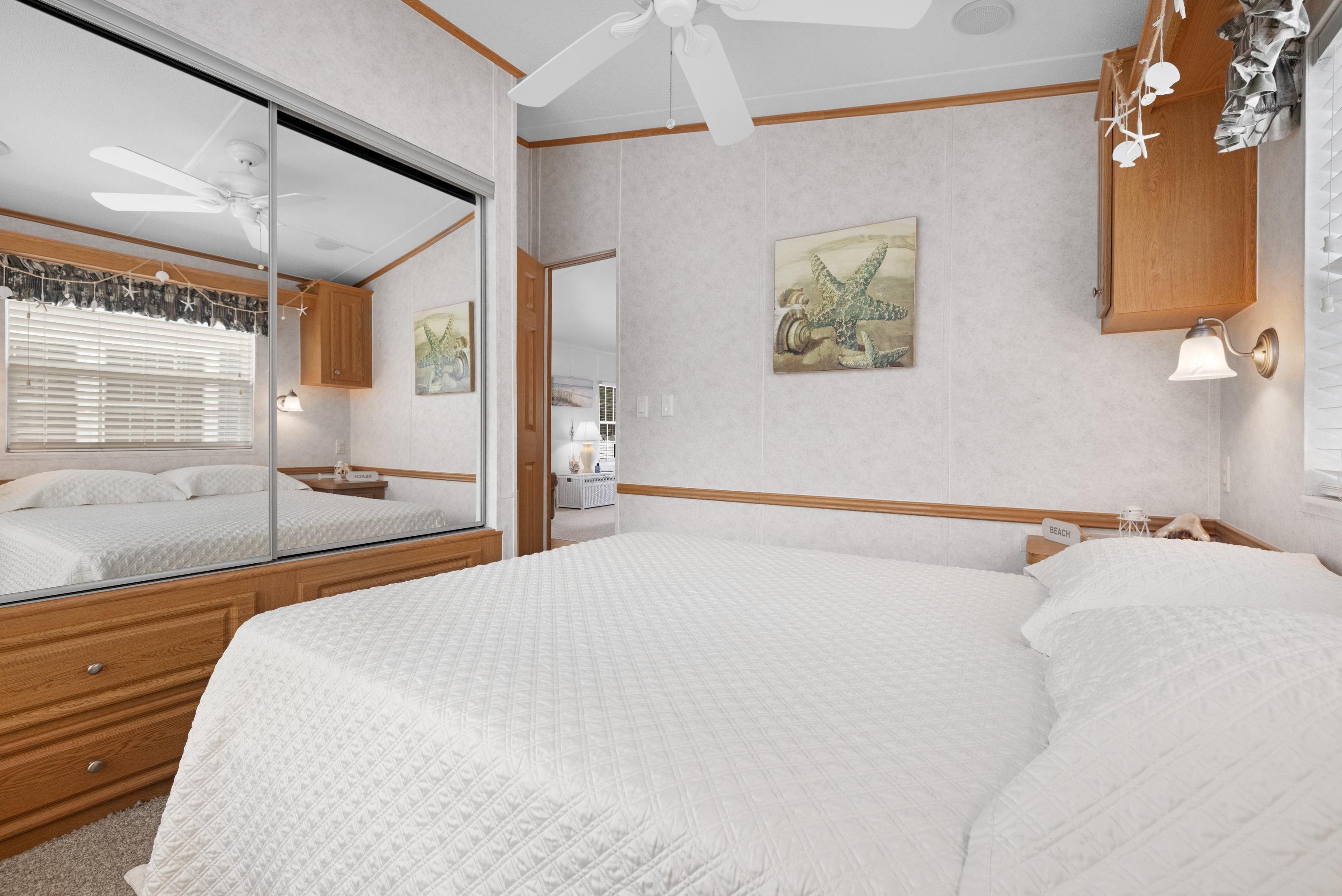 4100 Rte 9 South, Unit 6 Rio Grande, NJ 08242 - Photo 13 of 24 a bedroom with a large bed and a chandelier