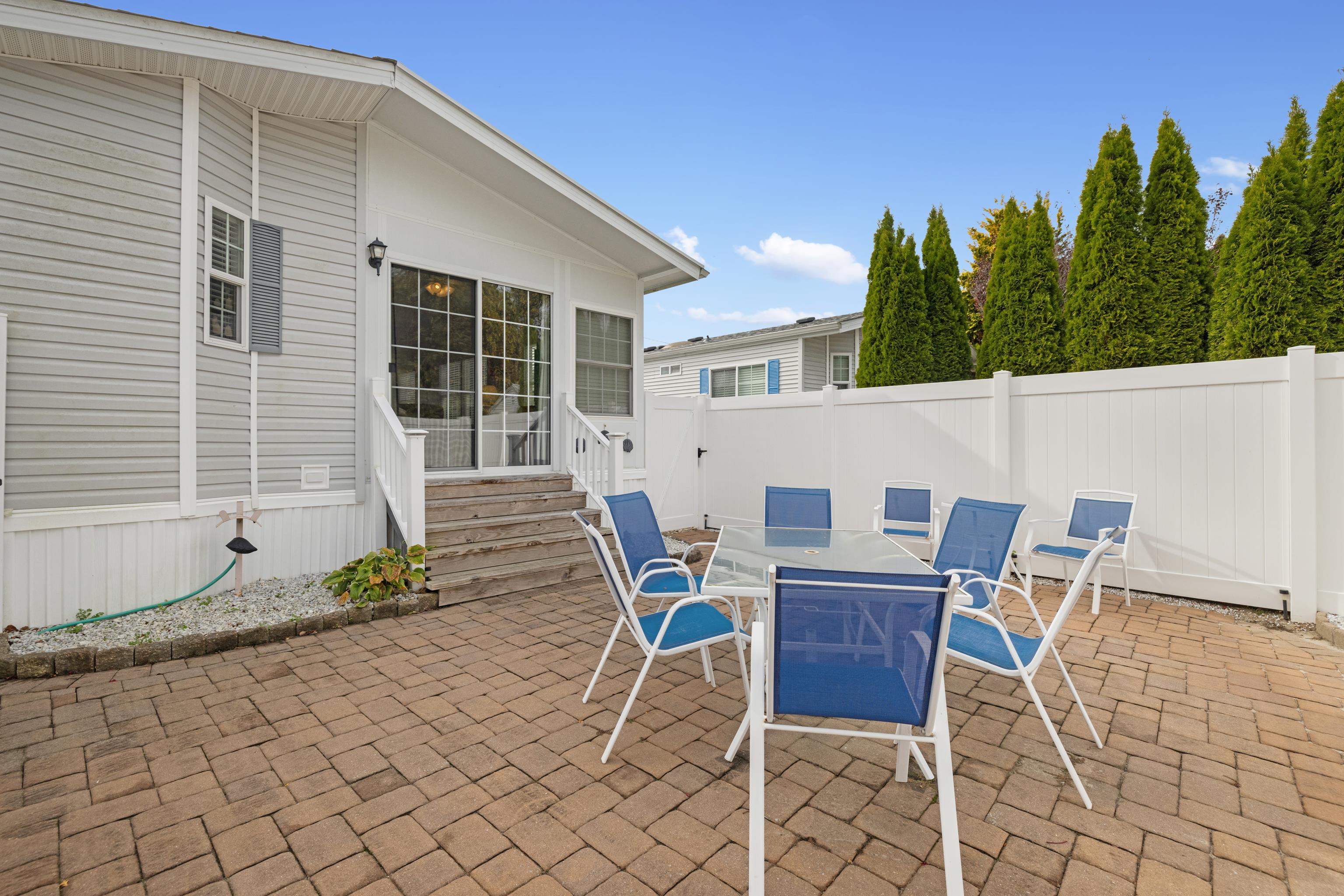 4100 Rte 9 South, Unit 6 Rio Grande, NJ 08242 - Photo 17 of 24 a view of a patio with table and chairs with wooden fence