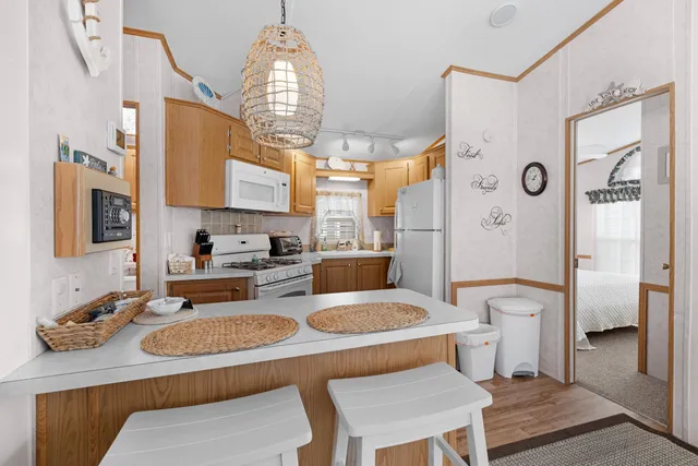 a white refrigerator freezer sitting inside of a kitchen