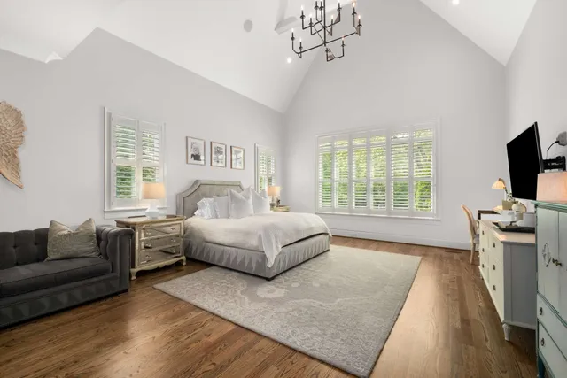 a bedroom with a bed and a large window