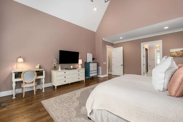 a bed sitting in a bedroom next to a window