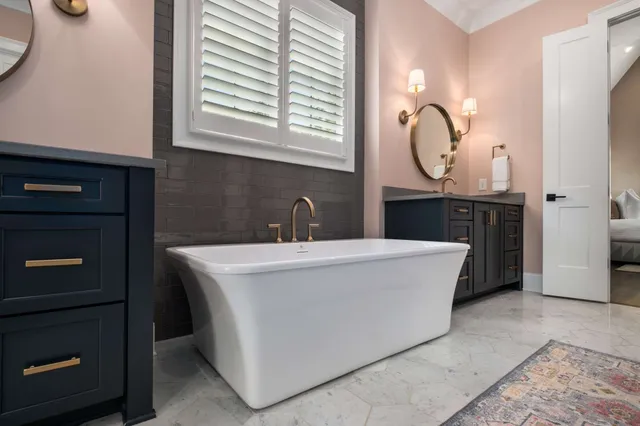 a bedroom with bed and a large window