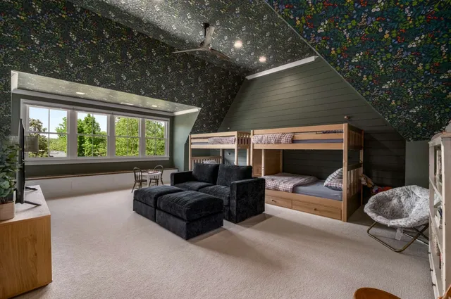 a work room with furniture and a large window