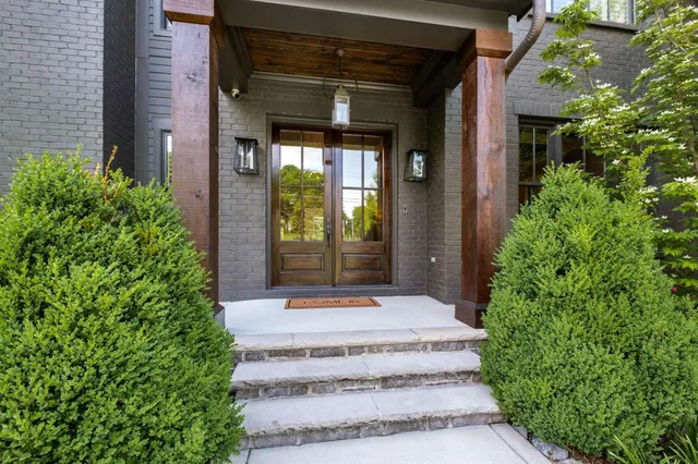 a dining room with wooden floor a chandelier a wooden table and chairs