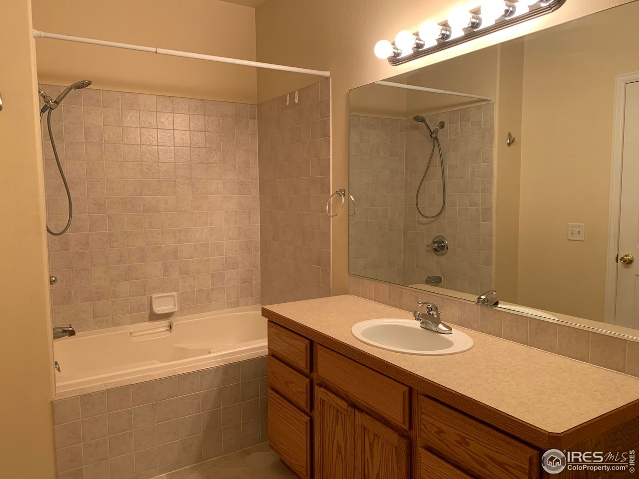 124 Beacon Way, Unit B Windsor, CO 80550 - Photo 11 of 26 a bathroom with a sink and a mirror