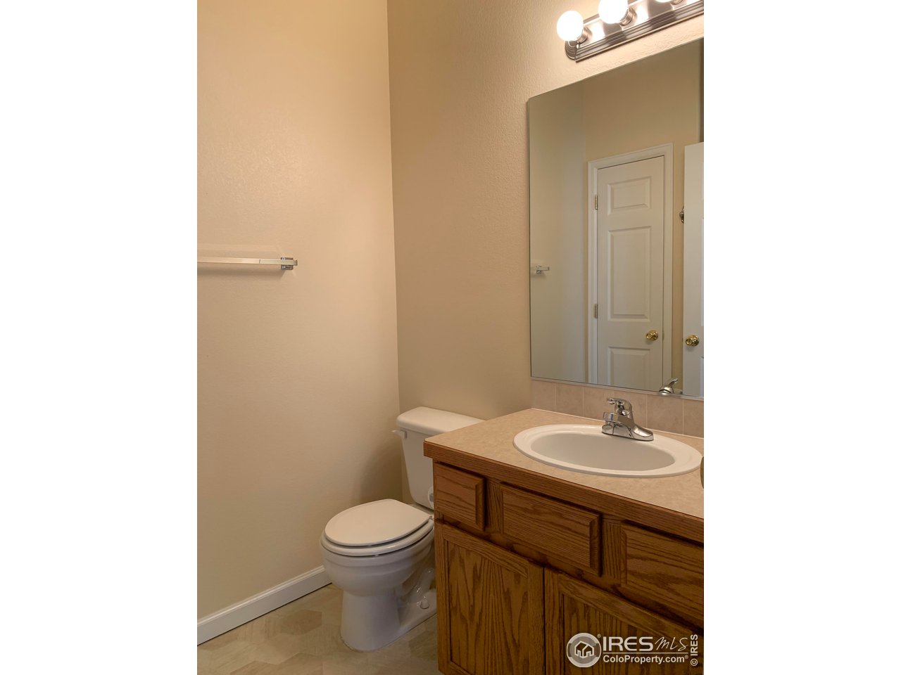 124 Beacon Way, Unit B Windsor, CO 80550 - Photo 14 of 26 a bathroom with a sink a toilet and mirror