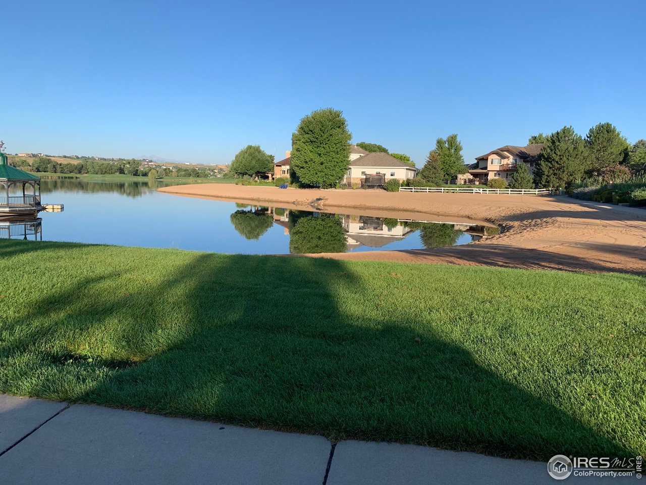 124 Beacon Way, Unit B Windsor, CO 80550 - Photo 18 of 26 a view of a lake with houses in the back