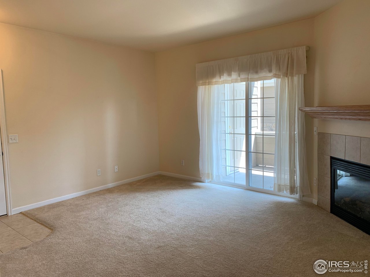124 Beacon Way, Unit B Windsor, CO 80550 - Photo 2 of 26 a view of an empty room with a window