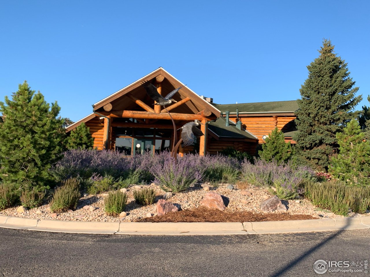 124 Beacon Way, Unit B Windsor, CO 80550 - Photo 21 of 26 front view of a house with a yard