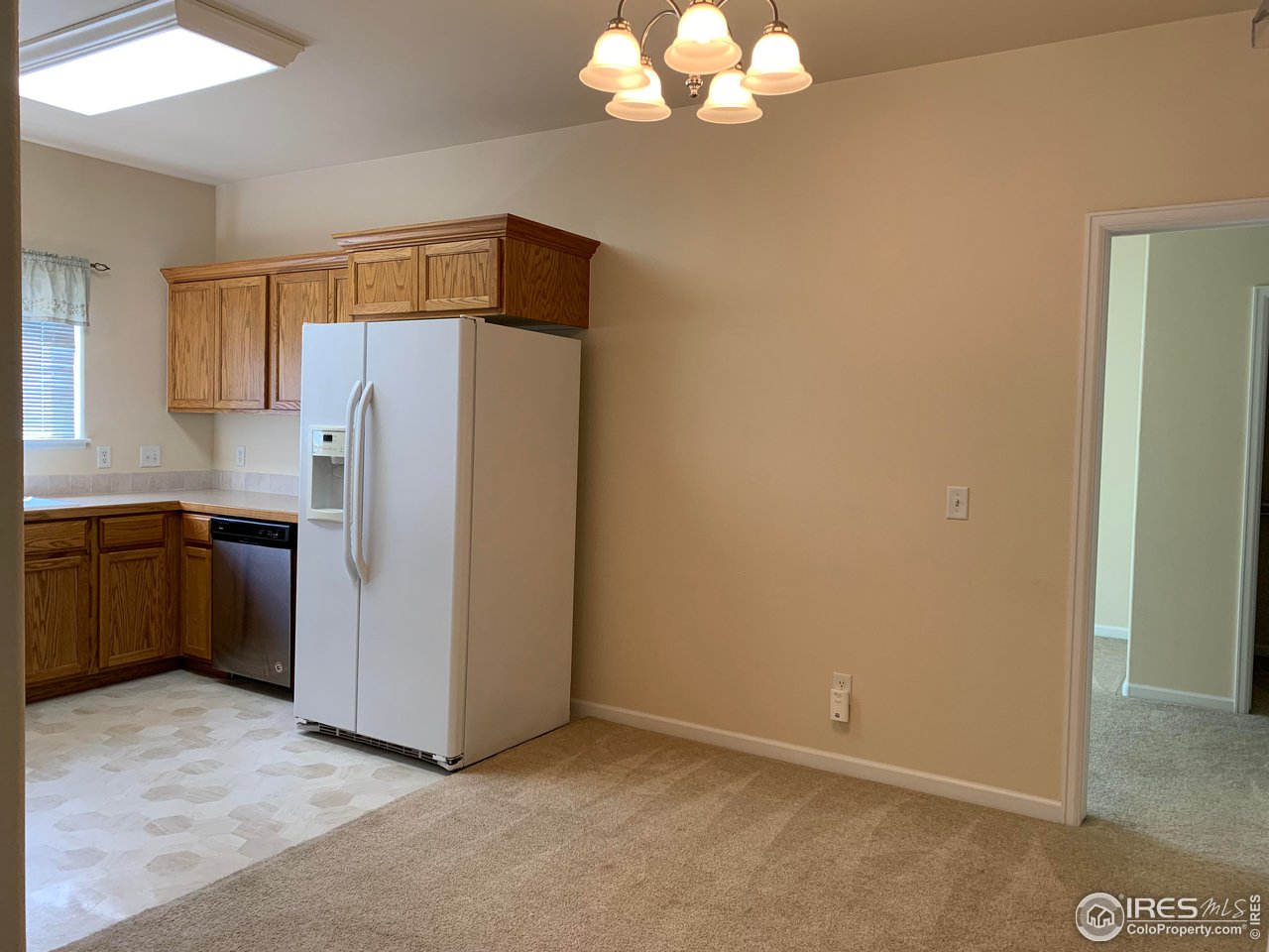 124 Beacon Way, Unit B Windsor, CO 80550 - Photo 4 of 26 a kitchen with a refrigerator a sink and dishwasher