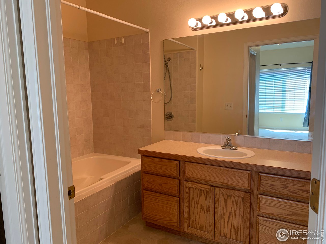 124 Beacon Way, Unit B Windsor, CO 80550 - Photo 10 of 26 a bathroom with a sink and a bathtub