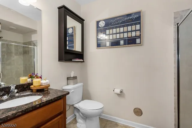 a bathroom with a granite countertop sink mirror and toilet