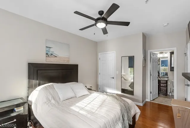 a bedroom with a bed and a ceiling fan