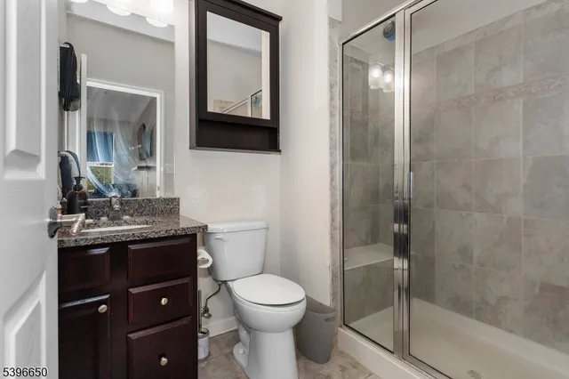 a bathroom with a toilet a sink and mirror