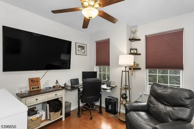 a view of a livingroom with workspace and a window