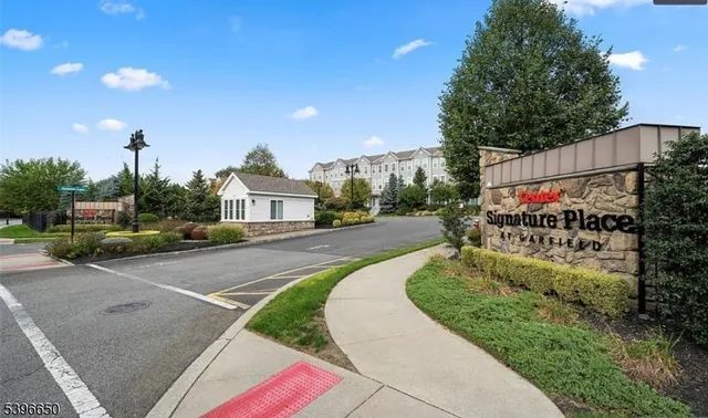 a front view of a house with a yard and a garden