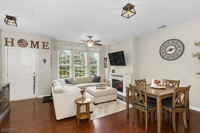 a living room with furniture a rug and a flat screen tv