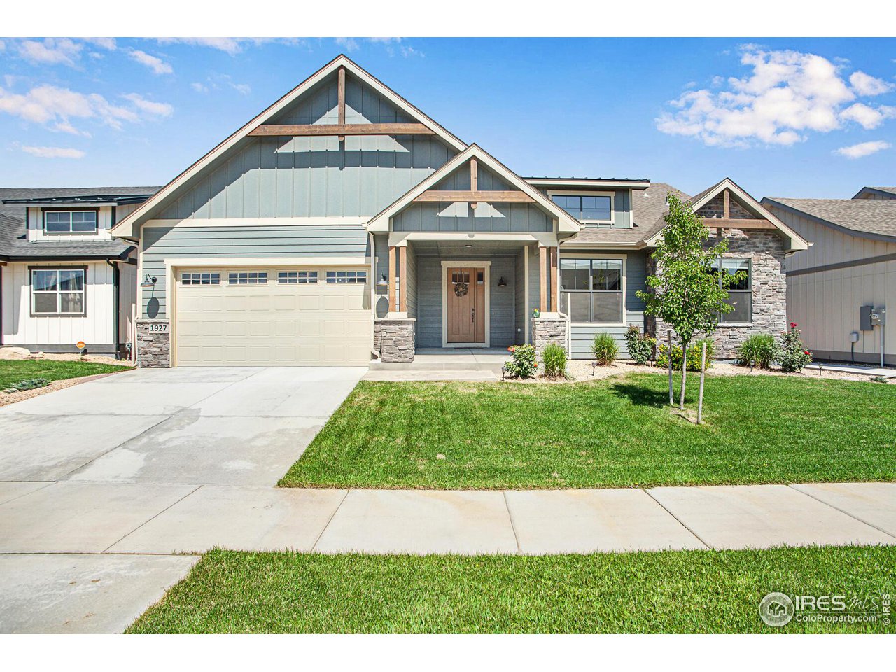 1927 Rolling Wind Drive Windsor, CO 80550 - Photo 1 of 31 a front view of a house with a yard and garage