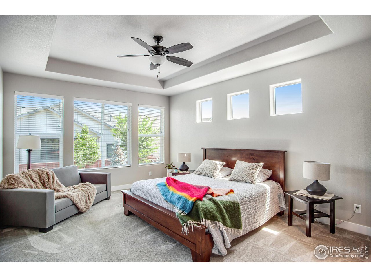 1927 Rolling Wind Drive Windsor, CO 80550 - Photo 14 of 31 a bedroom with a bed and a chandelier