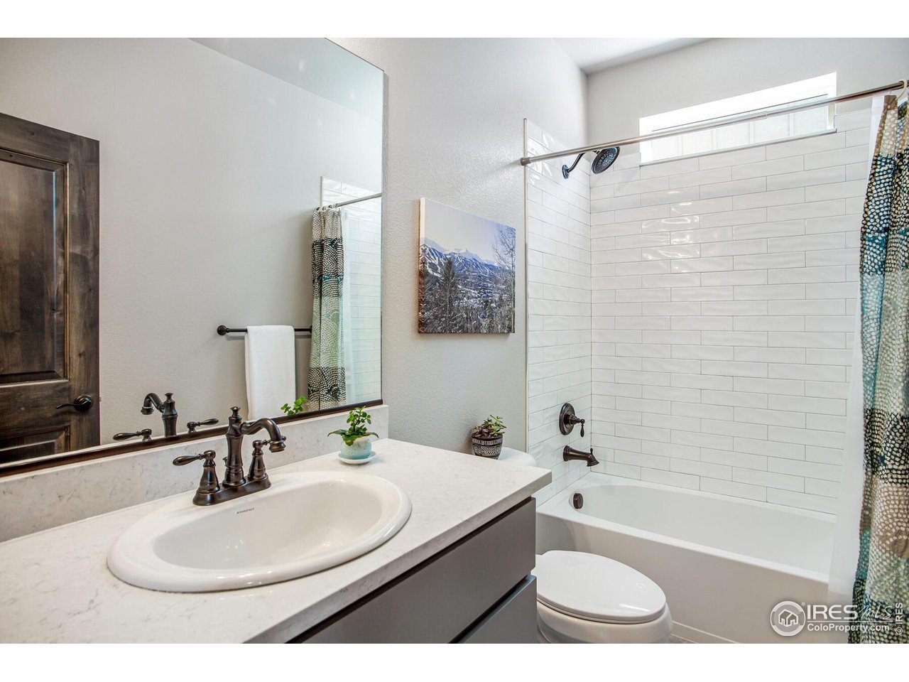 1927 Rolling Wind Drive Windsor, CO 80550 - Photo 18 of 31 a bathroom with a sink a toilet a mirror and shower