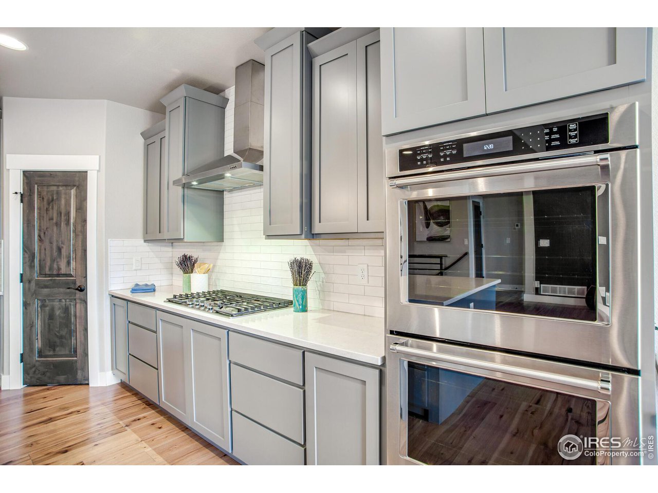 1927 Rolling Wind Drive Windsor, CO 80550 - Photo 8 of 31 a kitchen with stainless steel appliances granite countertop a stove and a sink