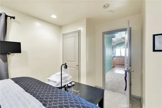 a bedroom with a bed and a mirror