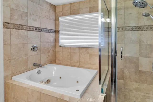 a bathroom with a tub and shower