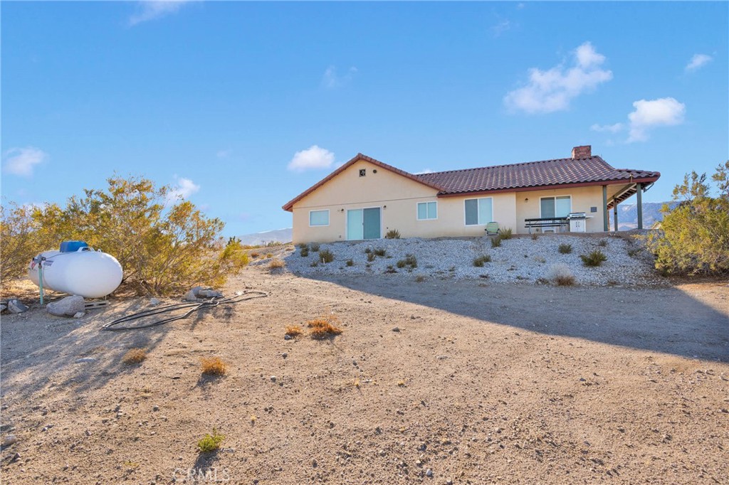 32758 Spinel Road Lucerne Valley, CA 92356 - Photo 32 of 40 a front view of a house with a yard