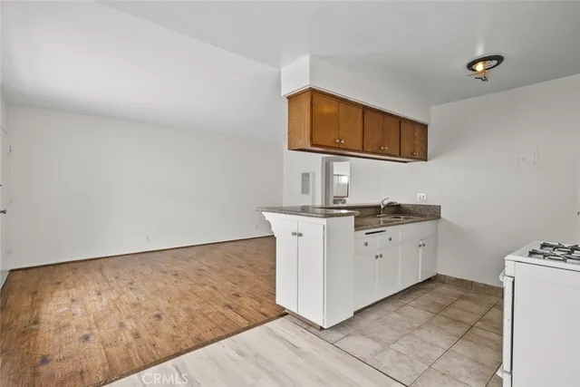 a kitchen with a stove top oven cabinets and a refrigerator