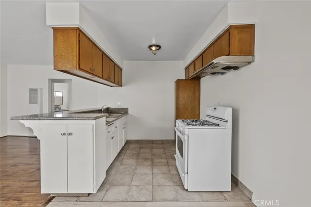 a kitchen with granite countertop cabinets and sink