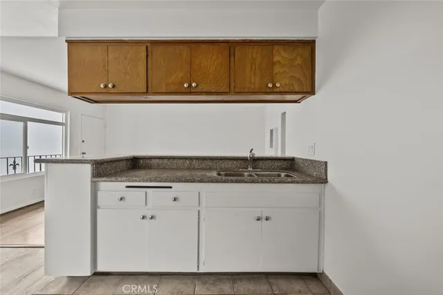 a kitchen with granite countertop cabinets and sink